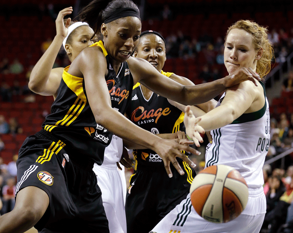 Tulsa Shock's Glory Johnson, left, and Seattle Storm's Chelsea Poppens reach for a loose ball in the second half of a preseason WNBA basketball game Friday, May 17, 2013, in Seattle. The Storm won 63-59. (AP Photo