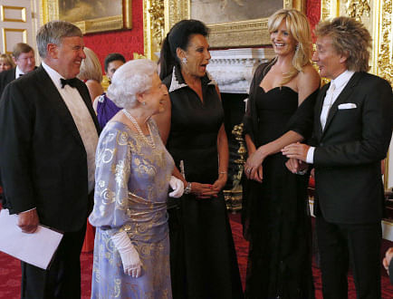 Britain's Queen Elizabeth (2nd L) speaks to Penny Lancaster (2nd R) and Rod Stewart (R) during a reception for the Royal National Institute for the Blind at St James Palace, in central London June 3, 2013. REUTERS