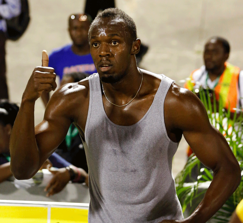 Jamaica's Usain Bolt gestures after winning the 100m men's final of the JAAA National Senior Trials, which determines the team to represent Jamaica in the IAAF World Championships Moscow, in Kingston June 21, 2013. REUTERS