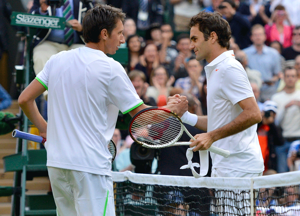 Sergiy Stakhovsky of Ukraine shakes hands with Roger Federer of Switzerland after defeating him in their men's singles tennis match at the Wimbledon Tennis Championships, in London Reuters
