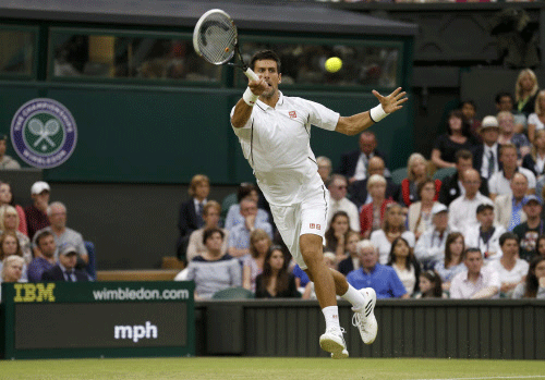 Novak Djokovic of Serbia hits a return to Bobby Reynolds of the U.S. during their men's singles tennis match at the Wimbledon Tennis Championships, in London Reuters