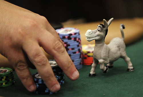 A donkey figurine helps guard a player's chips during the second day of the World Series of Poker Main Event in Las Vegas on Wednesday, July 10, 2013. (AP Photo