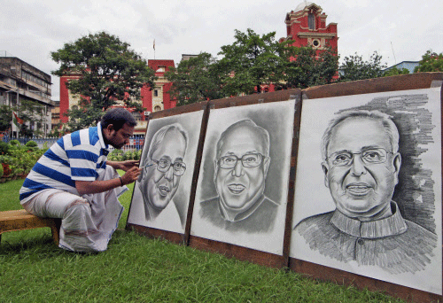 An artist Ramjan Hussain gives final touches on the pencil sketch of  President Pranab Mukherjee in Kolkata on Thursday. PTI Photo