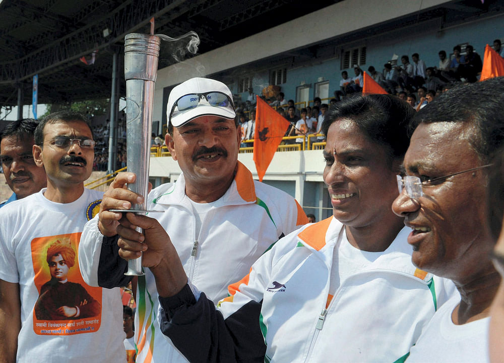 Bhopal:  Sprint legend PT Usha with former cricketer Madanlal and former  Hockey star Ashok Dhyanchand carrying 'torch' during 'Bharat Jago Daud'  in Bhopal on Wednesday. The run was organised by Rashtriya Swayamsevak  Sangh (RSS) to mark 150th birth...