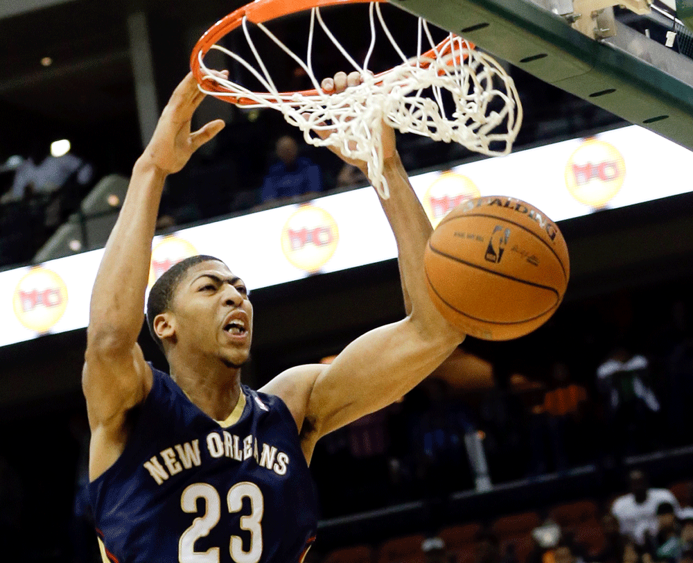 New Orleans Pelicans' Anthony Davis (23) dunks the ball against the Orlando Magic during the first half of an NBA preseason basketball game in Jacksonville, Fla., Wednesday, Oct. 9, 2013. (AP Photo
