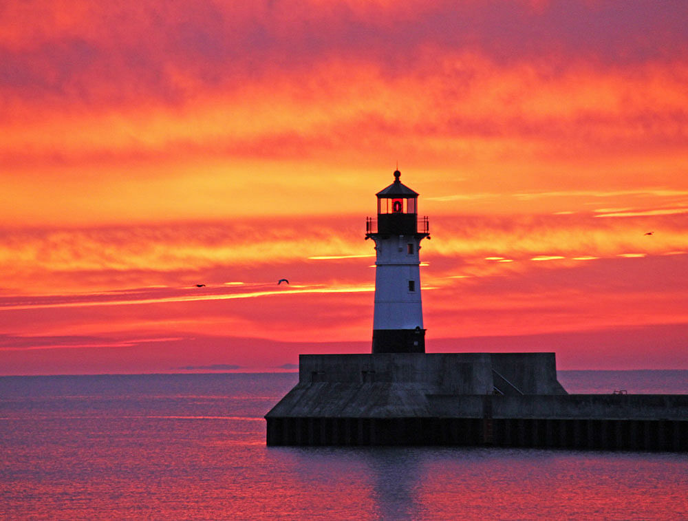 The sky above Lake Superior is filled with color at dawn Thursday, Oct. 17, 2013, as seen from Canal Park in Duluth, Minn. (AP Photo