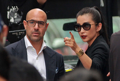 Chinese actress Li Bingbing gestures next to U.S. actor Stanley Tucci  during the filming of a scene for the movie 'Transformers: Age of  Extinction' in Hong Kong Reuters