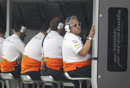 Force India team principal Vijay Mallya watches the second practice  session from the pit wall at the Indian Formula One Grand Prix at the  Buddh International Circuit in Noida, India, Friday, Oct. 25, 2013. AP photo