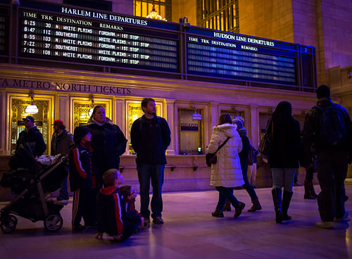 People and an empty electronic display for the Hudson line are seen in Grand Central Station after a Metro-North train derailment in the Bronx borough of New York December 1, 2013. A suburban New York train derailed on Sunday, killing four people and...