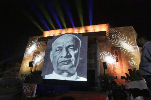 A huge portrait of freedom fighter Sardar Patel is projected on a screen  during an event in Ahmadabad, India, Friday, Dec. 13, 2013. The Gujarat  government aims at building the world’s biggest statue of Sardar Patel,  also known as the Iron Man o...