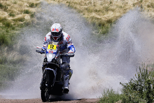 Yamaha rider Frans Verhoeven, of the Netherlands, races through a creek during the first stage of the Dakar Rally between the cities of Rosario and San Luis, Argentina, Sunday, Jan. 5, 2014. AP