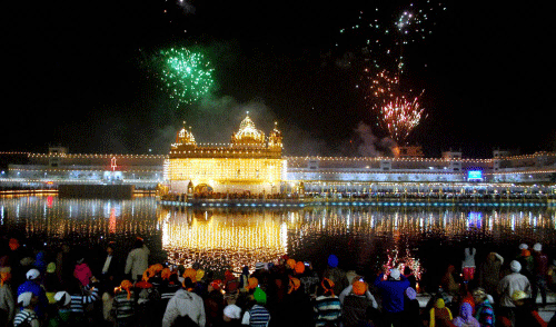 Devotees watch fire works on the occasion of 348th  birth anniversary of  Guru Gobind Singh, at Golden Temple in Amritsar on Tuesday.PTI Photo