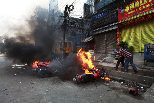 Vehicles burn after they were set on fire by activists of Islamist party, Jamaat-e-Islami, following the execution of their party leader Abdul Quader Mollah in Dhaka, Bangladesh, Friday, Dec. 13, 2013. The execution of the opposition leader in Bangla...