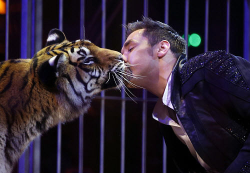 Jim Club performs with a tiger during the Award Gala evening of the 38th International Circus Festival of Monte Carlo in Monaco. (AP Photo)