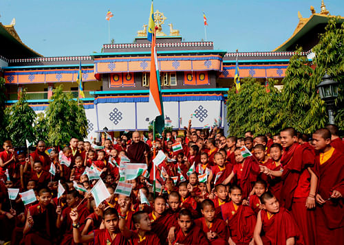 Young buddhist monks at Tergar Monastery celebrate the Republic day at Bodh Gaya on Sunday. PTI Photo