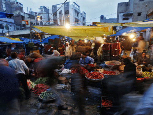 Vendors sell vegetables at a wholesale vegetable market in the old  quarters of Delhi in this January 22, 2014 file photo. Last week, a  committee formed by Reserve Bank of India Governor Raghuram Rajan  proposed making CPI the central bank's main in...