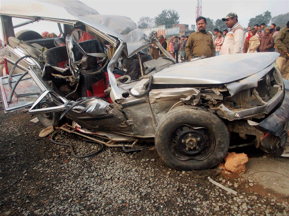 Malda : Police look at the wreckage of a car jeep after an accident near  Kaluadighi in Malda on Tuesday. PTI Photo (PTI2_11_2014_000089B)