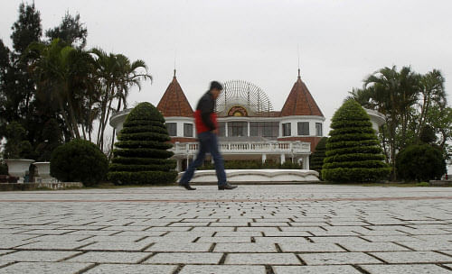 A man walks past Do Son casino in Vietnam's northern Hai Phong port city February 10, 2014. Despite its rigid stance on social order, the communist government and Vietnam's top tycoons are exploring ways to profit from what's currently illegal, while...