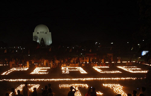 Supporters of Imran Khan, Pakistani cricketer-turned-politician and chairman of political party Pakistan Tehreek-e-Insaf (PTI), gather after they light earthen lamps during a peace vigil outside the mausoleum of Mohammad Ali Jinnah in Karachi March 9...