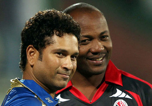 Cricket legends Sachin Tendulkar and Brian Lara pose for photographers during the Champions League T20 match between Mumbai Indians and Perth Scorchers at Ferozshah Kotla in New Delhi on Wednesday. PTI Photo 