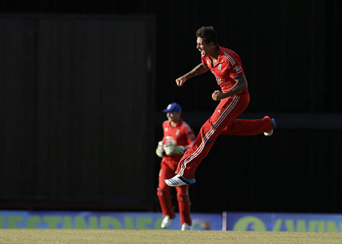 England's Jade Dernbach celebrates after beating West Indes during their third T20 International cricket match at the Kensington Oval in Bridgetown, Barbados, Thursday, March 13, 2014. England won by 5 runs. AP