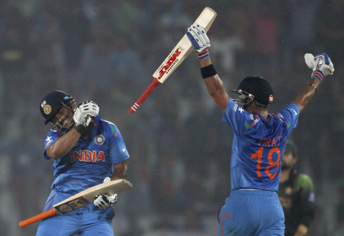 India's Virat Kohli (R) and Suresh Raina celebrate their victory against  Pakistan after their ICC Twenty20 World Cup cricket match at the  Sher-E-Bangla National Cricket Stadium in Dhaka March 21, 2014. REUTERS