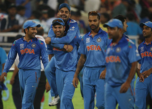 India's Yuvraj Singh, second left, carries teammate Virat Kohli on his back as they celebrate their win over Australia in their ICC Twenty20 Cricket World Cup match in Dhaka, Bangladesh, Sunday, March 30, 2014. India won the match by 73 runs. AP Phot...