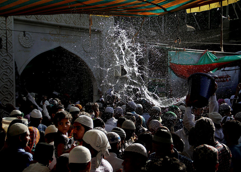 Ajmer: Devotees get showered with perfumed water at the end of the Urs festival at the shrine of Sufi saint Khwaja Moinuddin Chishti in Ajmer on Friday. PTI Photo (