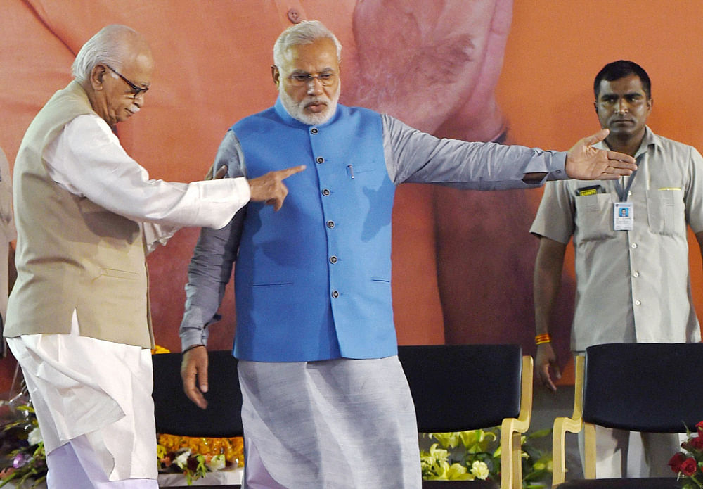 New Delhi: Bharatiya Janata Party leader and the next Prime Minister Narendra Modi with senior party leader L K Advani at a felicitation function at the party headquarters in New Delhi on Saturday. PTI Photo by Manvender Vashis