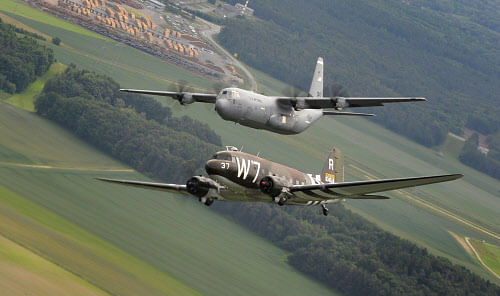 A former U.S. Air Force C-47 Skytrain aircraft (bottom) flies alongside a C-130J Super Hercules aircraft assigned to the 37th Airlift Squadron over Germany in this handout photo taken May 30 and released June 3, 2014. The C-47 visited Germany for a w...