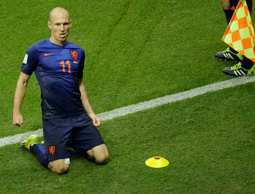 Netherlands' Arjen Robben celebrates after scoring during the group B World Cup soccer match between Spain and the Netherlands at the Arena Ponte Nova in Salvador, Brazil, Friday, June 13, 2014. AP