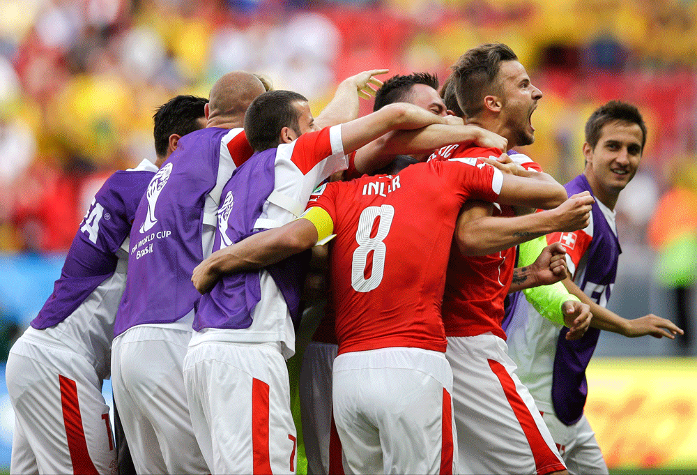 Switzerland's Haris Seferovic, right, celebrates after scoring his side's second goal during the group E World Cup soccer match between Switzerland and Ecuador at the Estadio Nacional in Brasilia, Brazil, Sunday, June 15, 2014. (AP Photo