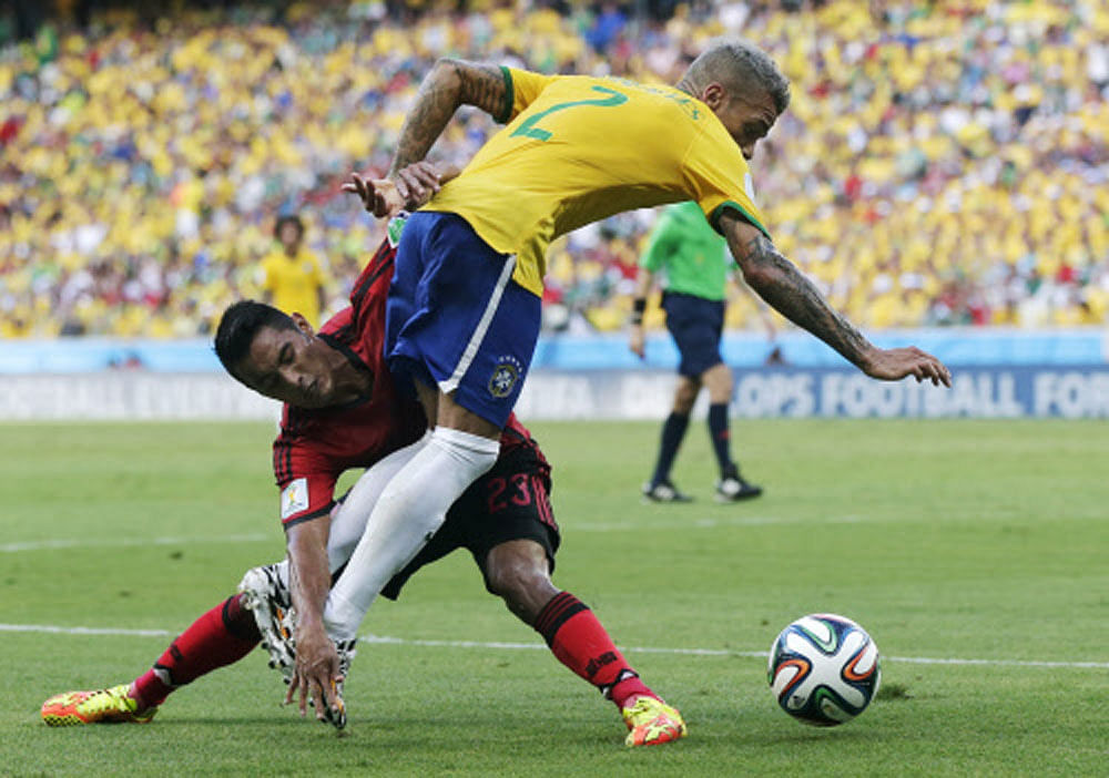 Brazil's Neymar, right, trips over Mexico's Jose Juan Vazquez during the group A World Cup soccer match between Brazil and Mexico at the Arena Castelao in Fortaleza, Brazil, Tuesday, June 17, 2014. (AP Photo