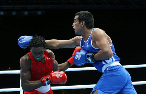 India's Mandeep Jangra, right, lands a punch on Jamaica's Kestna Davis  during their men's boxing  welterweight preliminarie round bout at the  Commonwealth Games Glasgow 2014, Glasgow, Scotland, Monday, July 28,  2014.AP