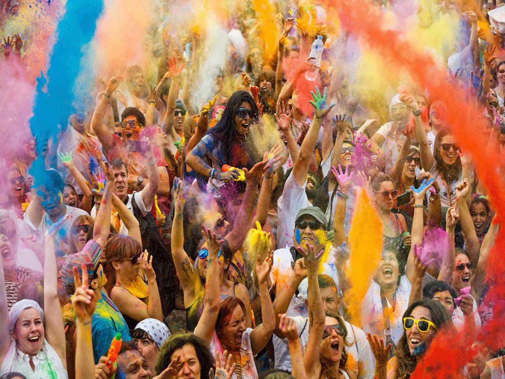 Revelers of the Holi Festival of Colors throw colored powders in the air in Madrid, Spain, Saturday, Aug. 9, 2014. The festival is fashioned after the Hindu spring festival Holi, which is mainly celebrated in the north and east areas of India. AP Pho...