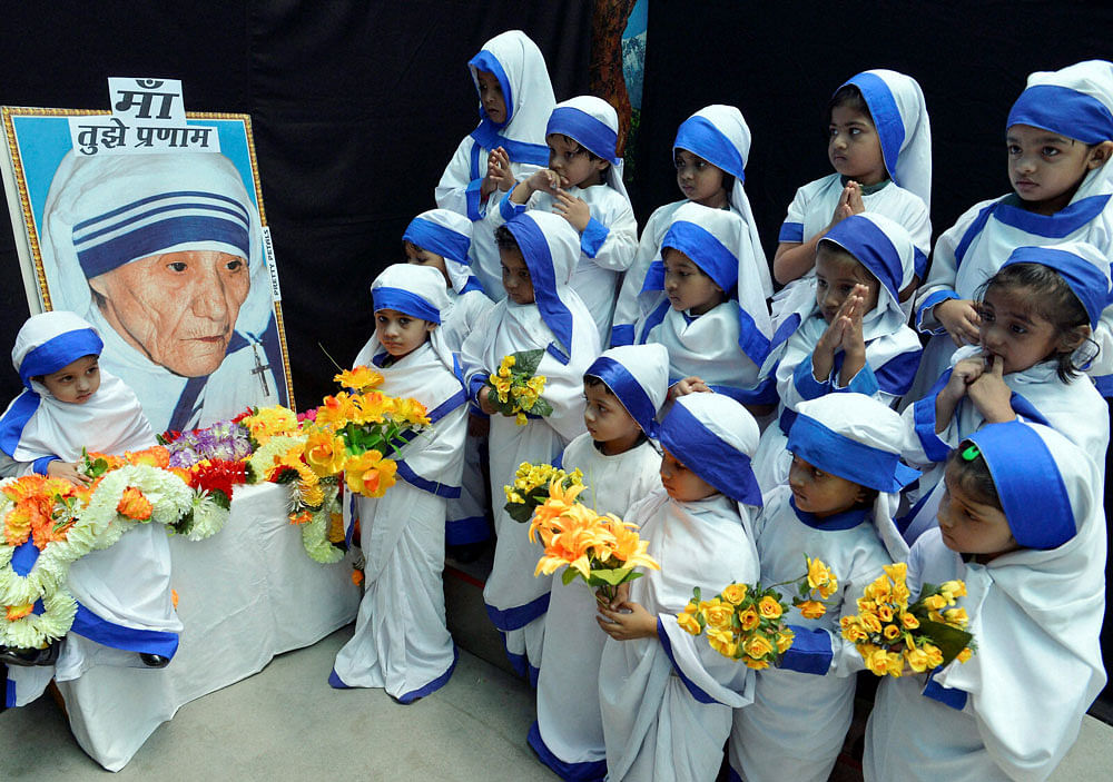 Bhopal: Children dressed as Mother Teresa offer prayers on the occaision of her birth anniversary in Bhopal on Tuesday. PTI Photo 