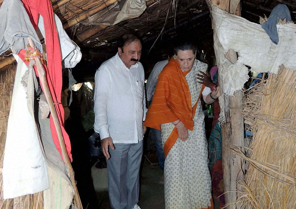 Congress president Sonia Gandhi in a village hut during a visit to her constituency Rae Bareli on Monday. PTI Photo