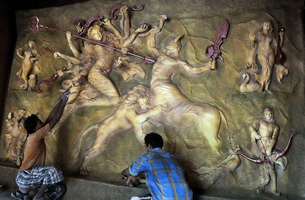 Kolkata: Artists give final touches to idols of Goddess Durga at Jodhpur Park puja pandal ahead of the festival in Kolkata on Wednesday. PTI Photo 