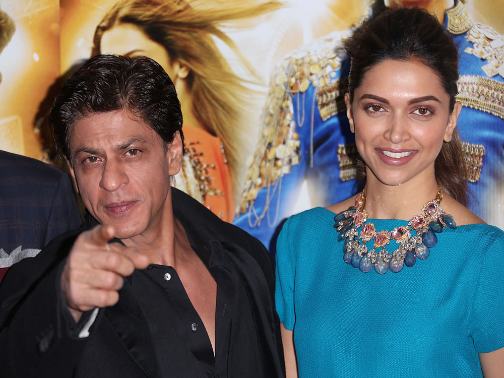 Bollywood actors Shah Rukh Khan, left, and Deepika Padukone pose for photographers during a photo call for the film, Happy New Year-SLAM, at the Montcalm hotel in central London, Sunday, Oct. 5, 2014. AP PHOTO