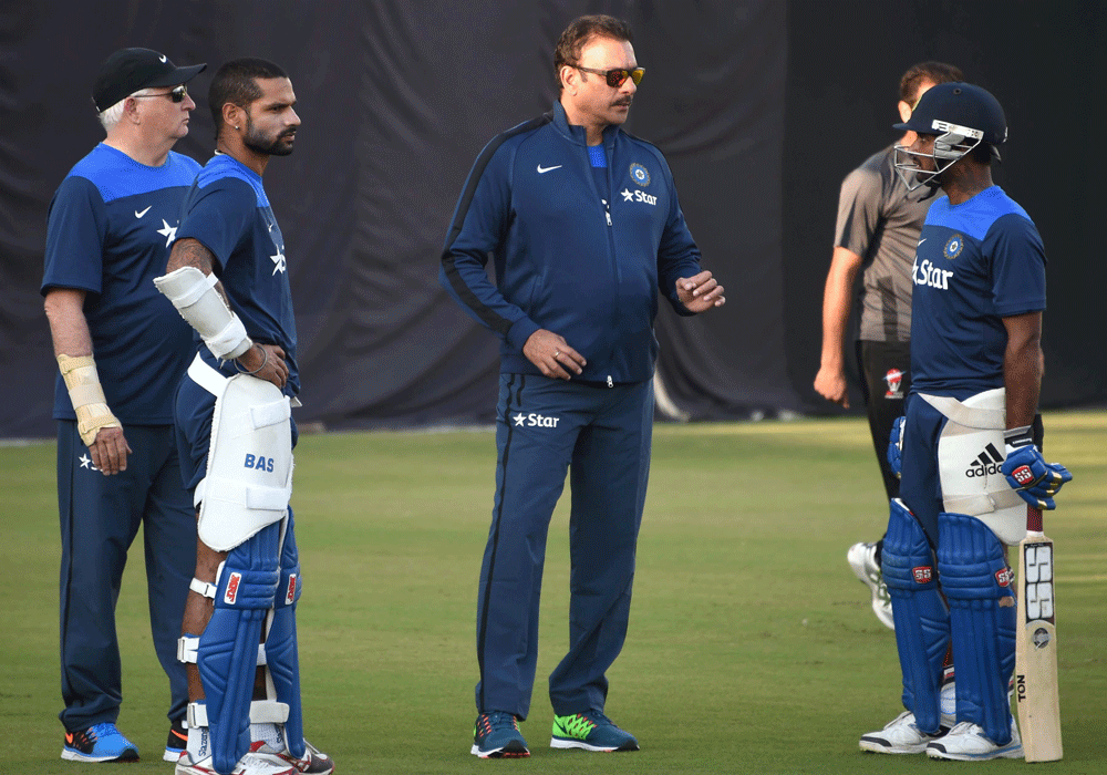 Dharamshala : Team India's director of cricket Ravi Shastri and coach  Duncan Fletcher with A Rayudu and Shikhar Dhawan during a practice  session in Dharamshala on Thursday ahead of the 4th ODI cricket match  against West Indies. PTI Photo