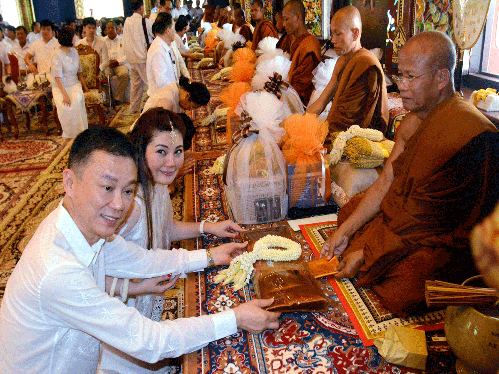 Brother of Thailand's Prime Minister Payap Shinawatra takes part in Robe offer ceremony at Bodhgaya Watpa temple on Saturday. PTI Photo