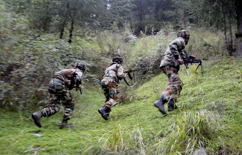 Handwara: Army soldiers take position during their search operation for militants hideouts in Handwara on Tuesday. PTI Photo