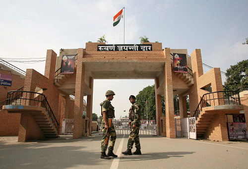 India's Border Security Force (BSF) soldiers patrol in front of the  golden jubilee gate at the Wagah border, on the outskirts of the  northern Indian city of Amritsar, November 3, 2014. India and Pakistan  have suspended a daily military ritual on t...