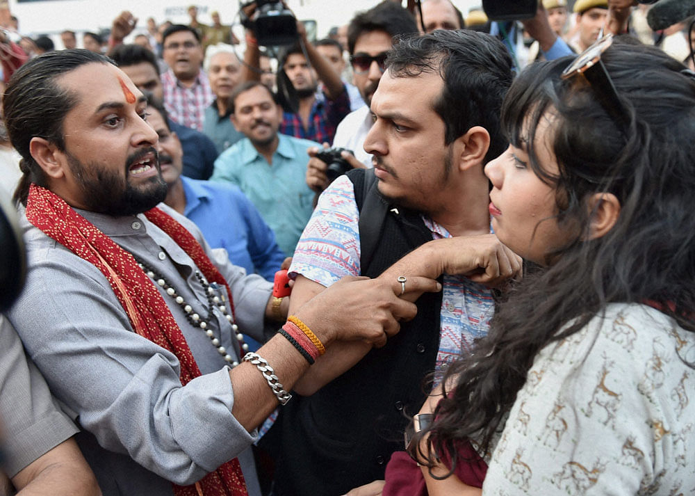 New Delhi: 'Kiss of Love' (campaign against moral policing) activists (R) and Hindu activists (L) argue outside RSS headquarters in New Delhi on Saturday. PTI Photo 