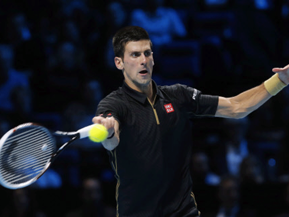 Novak Djokovic of Serbia returns the ball to Stan Wawrinka of  Switzerland during their tennis match at the ATP World Tour finals at  the O2 Arena in London November 12, 2014. Reuters Photo