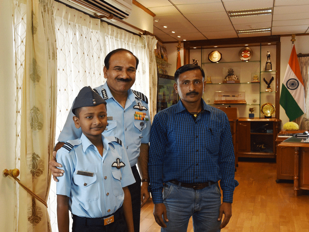 IAF chief Air Chief Marshal Arup Raha with 14-year-old Chandan who is  fighting bone cancer, and his father at a meeting at Air Headquarters in  New Delhi on Friday.  Chandan who wanted to become a fighter pilot till  he was diagnosed with bone cance...