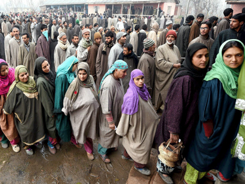 People queue up to cast their votes at a polling station in Bandipora in Jammu and Kashmir on Tuesday. PTI Photo