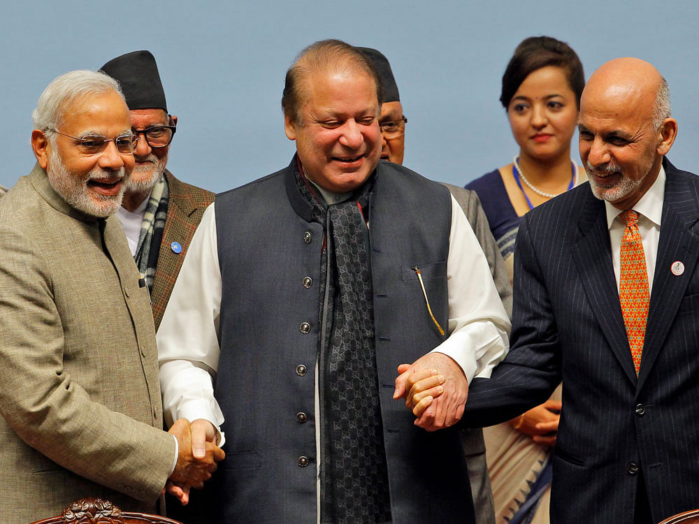 Pakistani Prime Minister Nawaz Sharif, center, holds hands with Indian Prime Minister Narendra Modi, left, and Afghanistan President Ashraf Ghani during the closing session of the 18th summit of the South Asian Association for Regional Cooperation (S...