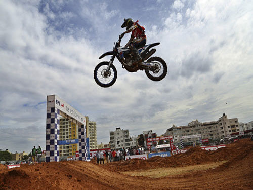 Participant Harith Noah jumps over the muddy track at the National Supercross Championship in Bangalore, India, Sunday, Nov. 30, 2014. More than 50 riders participated in the national-level motorcycle championship.