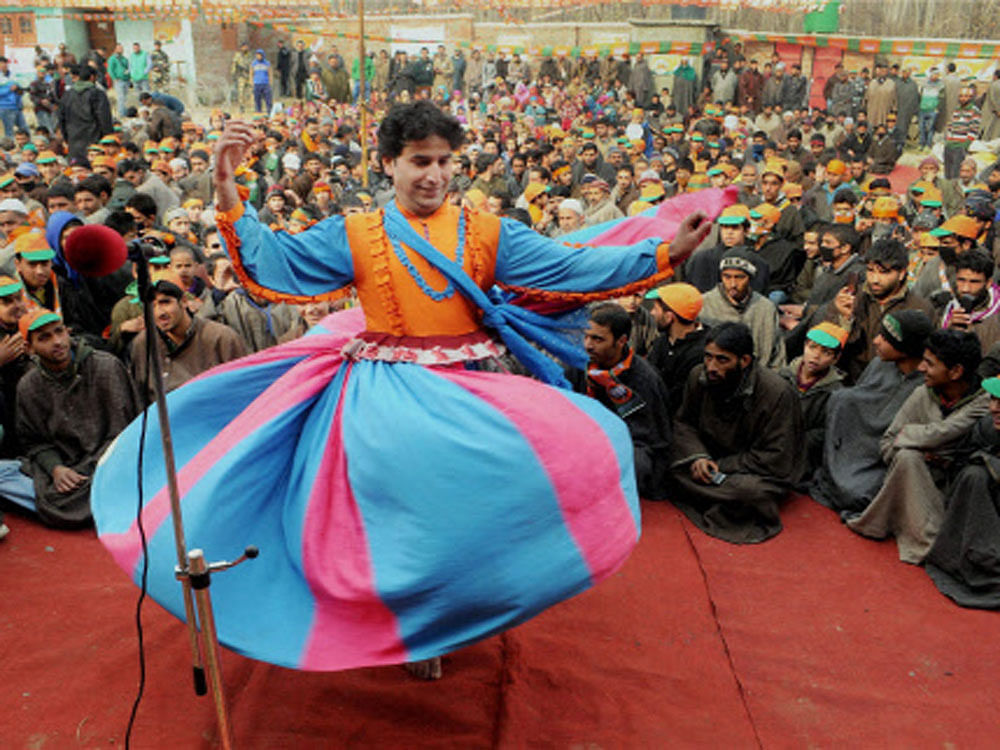  A Kashmiri folk dancer performs during BJP President Amit Shah's election campaign rally at Monshwara in Shopian district on Thursday. PTI Photo
